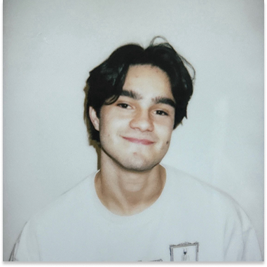 Elijah in front of a white background with a fuzzy polaroid filter